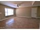 An open living room with a neutral palette, ceiling fan, and a window bringing in natural light at 3216 E Campo Bello Dr, Phoenix, AZ 85032