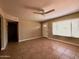 Inviting living room with neutral walls, tiled floor, ceiling fan, and a bright window at 3216 E Campo Bello Dr, Phoenix, AZ 85032