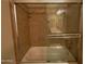 Shower and tub combination with decorative tile and a sliding glass door at 3216 E Campo Bello Dr, Phoenix, AZ 85032
