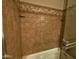 Shower and tub combination with decorative tile and two shower shelves at 3216 E Campo Bello Dr, Phoenix, AZ 85032