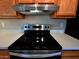 Modern kitchen features a stainless steel stove and range hood with oak cabinets at 3216 E Campo Bello Dr, Phoenix, AZ 85032