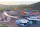 Aerial view showcases a modern home on a desert hillside with a private driveway, offering seclusion and panoramic views at 3502 S Kings Ranch Rd, Gold Canyon, AZ 85118