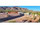 Expansive exterior shot featuring a modern white home with a three-car garage, complemented by a desert landscape and mountain views at 3502 S Kings Ranch Rd, Gold Canyon, AZ 85118