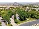 An aerial view shows this charming property in a lush neighborhood with beautiful mountain views in the distance at 3750 E Palm St, Mesa, AZ 85215