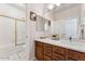 Bathroom featuring a vanity with drawers, a large mirror, and a shower with glass door at 3750 E Palm St, Mesa, AZ 85215