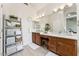 Bathroom featuring double sinks, mirrors, wood cabinets, and a ladder style towel rack at 3750 E Palm St, Mesa, AZ 85215