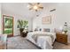 Bedroom with a ceiling fan and a door leading to an outside garden at 3750 E Palm St, Mesa, AZ 85215