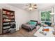 Comfortable bedroom with a ceiling fan, large window and a built-in bookcase at 3750 E Palm St, Mesa, AZ 85215
