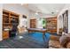 Spacious game room with pool table, custom bookshelves, and built-in desk at 3750 E Palm St, Mesa, AZ 85215