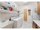 Laundry room with washer, dryer, utility sink, and shelving at 3750 E Palm St, Mesa, AZ 85215