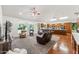 Open concept living room with kitchen, hardwood floors, and large windows overlooking the yard at 3750 E Palm St, Mesa, AZ 85215