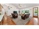 Open living room with vaulted ceilings, large windows, ceiling fan and plush seating at 3750 E Palm St, Mesa, AZ 85215