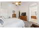 Spacious main bedroom featuring wood furniture and access to an ensuite bathroom and walk in closet at 3750 E Palm St, Mesa, AZ 85215