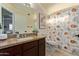 Bathroom featuring updated vanity with granite countertop and a shower-tub combo at 4049 E Arbor Ave, Mesa, AZ 85206