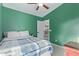 Bedroom featuring green walls with a ceiling fan and access to the upper level at 4049 E Arbor Ave, Mesa, AZ 85206