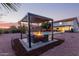 Backyard pergola-covered firepit area, complete with seating and outdoor features at 4049 E Arbor Ave, Mesa, AZ 85206