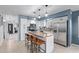 Lovely kitchen with stainless steel appliances, granite countertops, white cabinets, and a center island with seating at 4049 E Arbor Ave, Mesa, AZ 85206