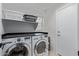 Functional laundry room featuring a washer, dryer, and shelving for storage at 4049 E Arbor Ave, Mesa, AZ 85206