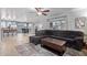 Open concept living room connected to the dining area and kitchen with a comfortable sectional sofa and a stylish coffee table at 4049 E Arbor Ave, Mesa, AZ 85206