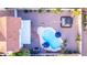 Aerial view of backyard featuring a pebble landscape, pool with umbrellas, and shaded pergola at 4049 E Arbor Ave, Mesa, AZ 85206