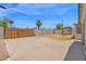 View of the backyard featuring concrete slab, a gated area, and mature palm trees at 4112 N 4Th Ave, Phoenix, AZ 85013