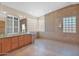 Bathroom featuring dual sinks, a glass block window, and a spacious walk-in shower at 4112 N 4Th Ave, Phoenix, AZ 85013