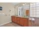 Bright bathroom featuring dual glass vessel sinks, granite countertops, and stylish glass block window at 4112 N 4Th Ave, Phoenix, AZ 85013