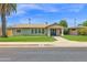Charming single-story home featuring a well-maintained lawn, palm tree, and welcoming double-door entryway at 4112 N 4Th Ave, Phoenix, AZ 85013