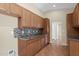 View of the kitchen showcasing the granite countertops, mosaic backsplash, and wood cabinetry at 4112 N 4Th Ave, Phoenix, AZ 85013