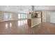 Spacious living room and kitchen area with wood floors and large windows allowing for natural light at 4112 N 4Th Ave, Phoenix, AZ 85013
