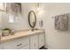 Charming bathroom featuring a tile countertop, oval mirror, and decorative accents at 5221 E Mills Ct, Mesa, AZ 85215