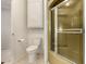 Bathroom with a toilet, storage cabinet, and a glass door shower at 5221 E Mills Ct, Mesa, AZ 85215