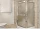 Shower stall with glass door, tile, and built-in cabinets in bathroom at 5221 E Mills Ct, Mesa, AZ 85215