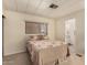 Bedroom with a window, carpet, and easy access to the bathroom at 5221 E Mills Ct, Mesa, AZ 85215