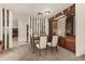 Dining area featuring a wooden table, chair set, and stylish built-in cabinet at 5221 E Mills Ct, Mesa, AZ 85215