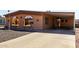 Cozy home featuring covered parking, gravel yard, and brick accents at 5221 E Mills Ct, Mesa, AZ 85215