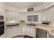 Well-lit kitchen with white cabinets, tile counters, and stainless steel dishwasher at 5221 E Mills Ct, Mesa, AZ 85215