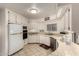 Clean kitchen featuring white cabinets, tile floors, and modern appliances at 5221 E Mills Ct, Mesa, AZ 85215