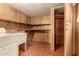 Functional laundry room with vintage sink and a storage closet at 5221 E Mills Ct, Mesa, AZ 85215