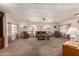 Comfortable living room featuring arched windows, ceiling fan, and ample seating at 5221 E Mills Ct, Mesa, AZ 85215