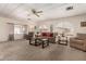 Bright living room with arched windows, neutral decor, and cozy seating arrangement at 5221 E Mills Ct, Mesa, AZ 85215