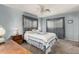 Cozy bedroom with soft blue walls, carpet, and a decorative ceiling fan at 5221 E Mills Ct, Mesa, AZ 85215