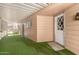 Covered patio space with turf and access to house at 5221 E Mills Ct, Mesa, AZ 85215