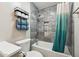 Modern bathroom featuring tiled walls, shower with curtain, and toilet at 5224 S Monaco Dr, Tempe, AZ 85283