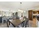 Well-lit dining area features wood flooring, updated lighting, and flows to the kitchen and living room at 5224 S Monaco Dr, Tempe, AZ 85283