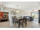 Open-concept dining room with modern lighting fixture over a wood table set and comfortable seating at 5224 S Monaco Dr, Tempe, AZ 85283