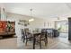 Open-concept dining room with modern lighting fixture over a wood table set and comfortable seating at 5224 S Monaco Dr, Tempe, AZ 85283