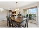 Well-lit dining room featuring a dark wood table, seating for six, and modern light fixture at 5224 S Monaco Dr, Tempe, AZ 85283