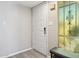 Simple and clean entryway featuring a white front door, sidelight window and light wood-look floors at 5224 S Monaco Dr, Tempe, AZ 85283