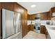 Well-lit kitchen with stainless appliances, wood cabinets, and modern backsplash at 5224 S Monaco Dr, Tempe, AZ 85283